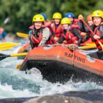 Group of friends enjoying themself with river rafting water sports