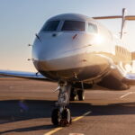 A sunlit view of a white plane’s exterior