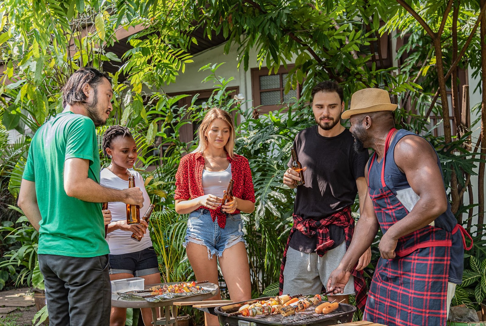 Group of people having barbeque and drinks